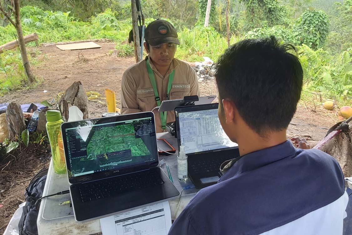 Enmintech Surveyors conducting Geophysical Survey in the Field on Laptops with GIS Software