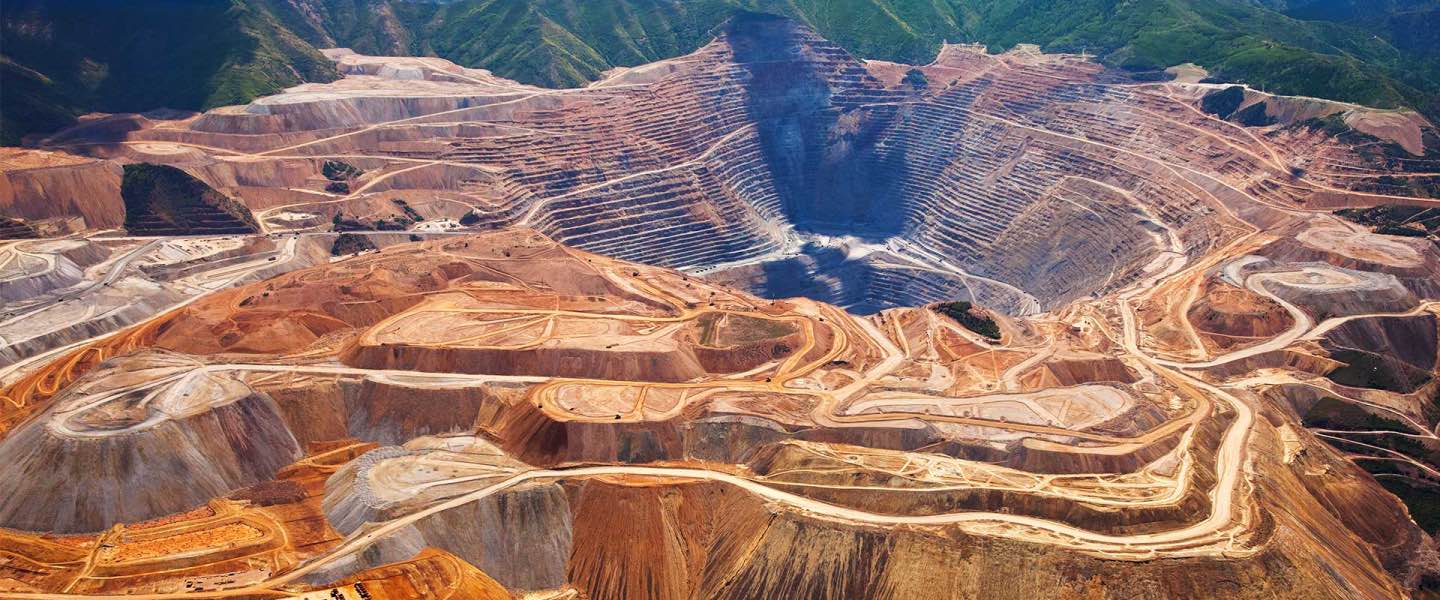 Large Open Pit Mine Surrounded by Mountains